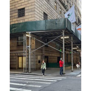 New York city sidewalk shed with plywood parapet.