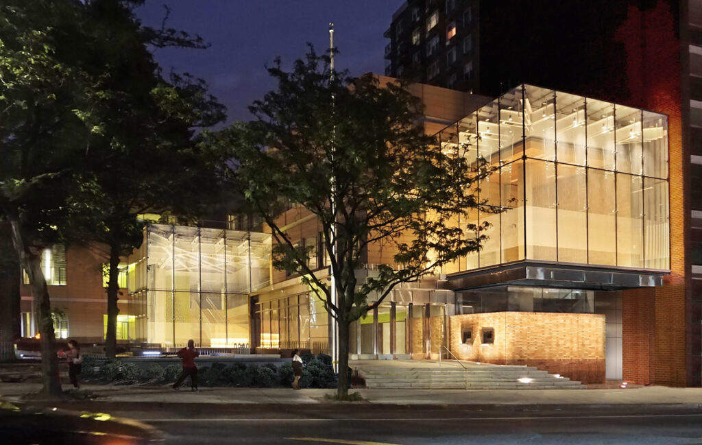 Queens Public Library Elmhurst illuminated at night.